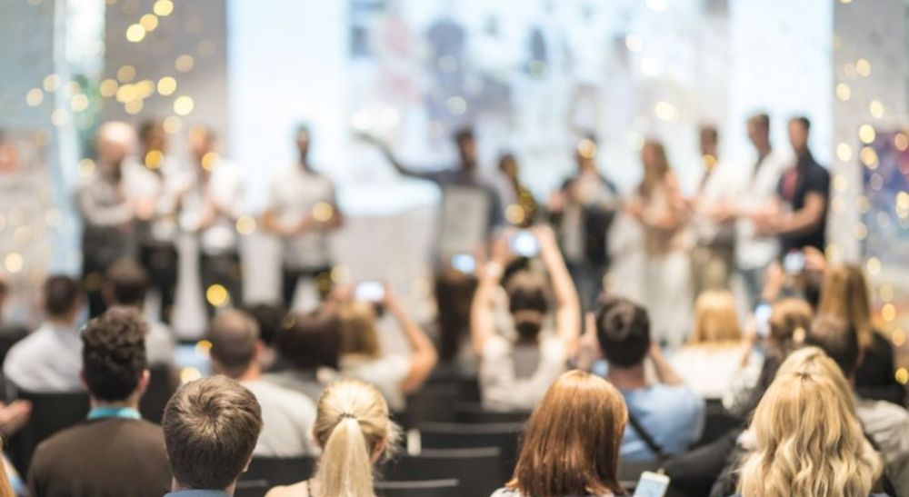 prizes-awards-teaser-card-homepage-crop a group of people celebrating in a room