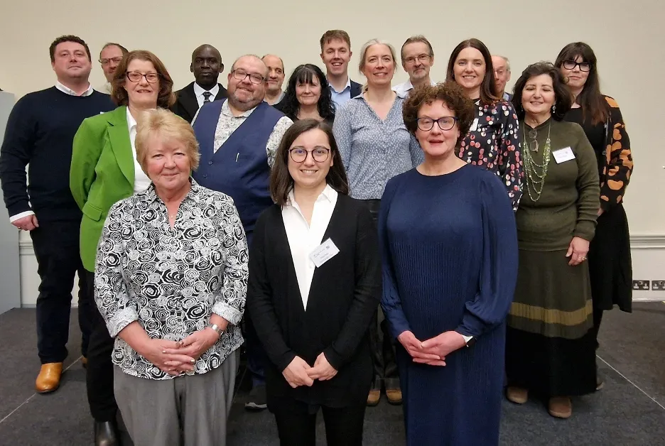 Sue Patel, Neslihan Taş and Dr Clare Hazel (left to right) stand in front of the rest of the attendees at the RSC Food Group's 50th-anniversary celebrations