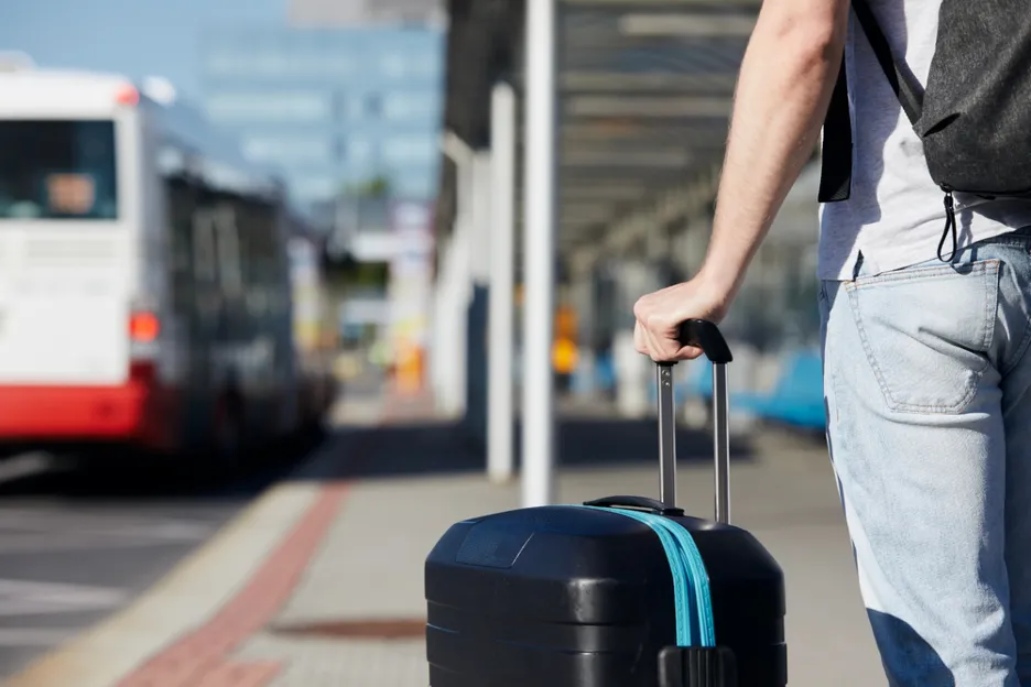 person holding suitcase outside