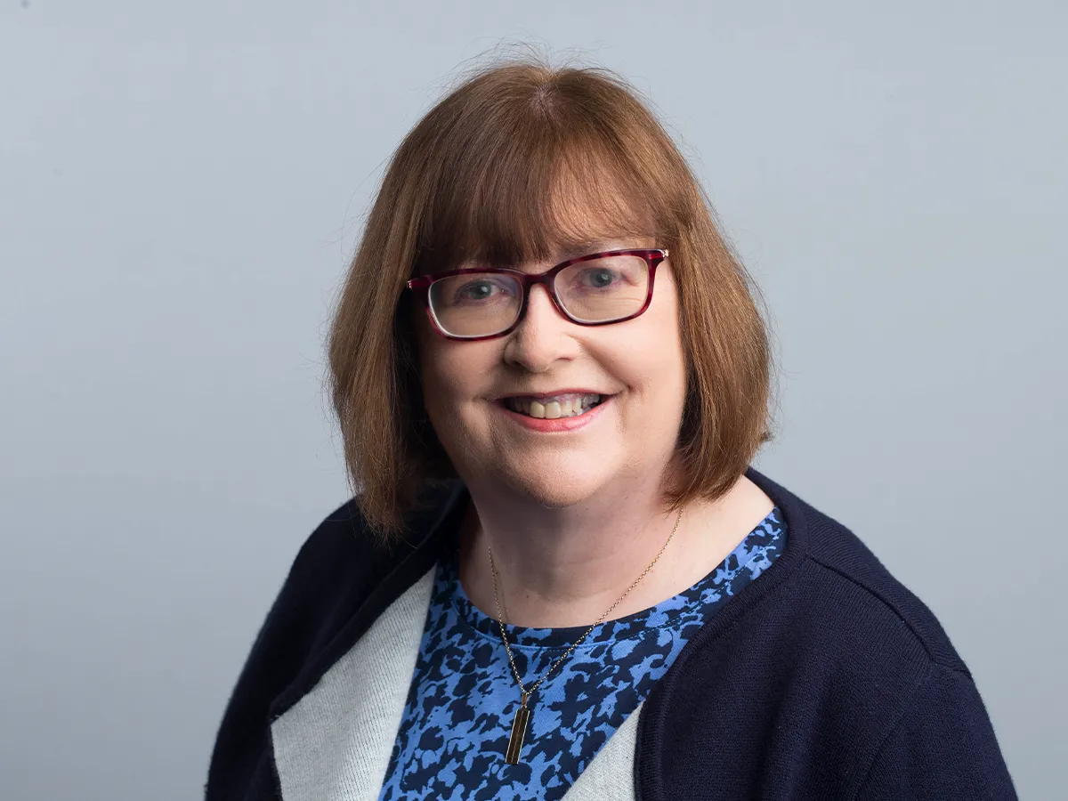 Professor Anita Maguire wearing glasses smiling for camera
