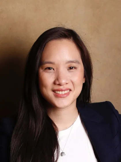 Dr Florence Huynh in a suit, smiling