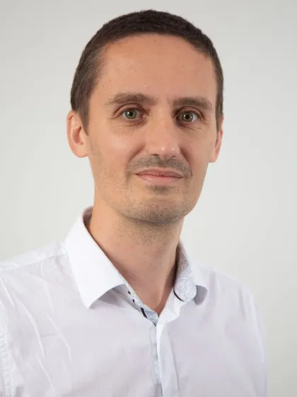 Professor Stephen Goldup in a white shirt, smiling to camera